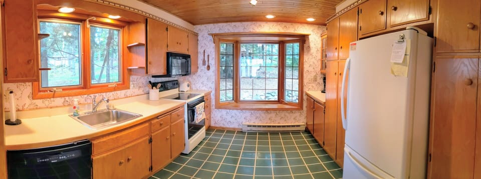Full kitchen with plates, glasses, silverware, pots, pans and more.
