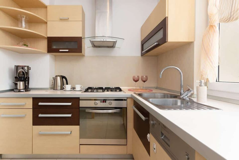 The kitchen's sleek design includes all necessary cookware and utensils.