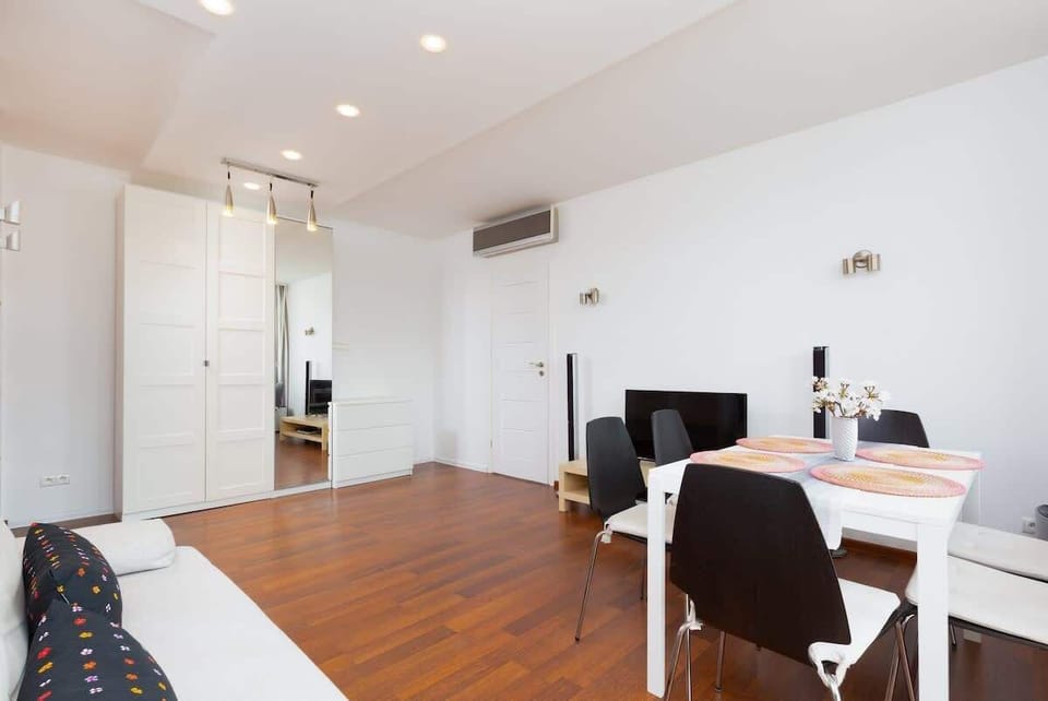 A large dining table with six chairs is perfect for family meals. 