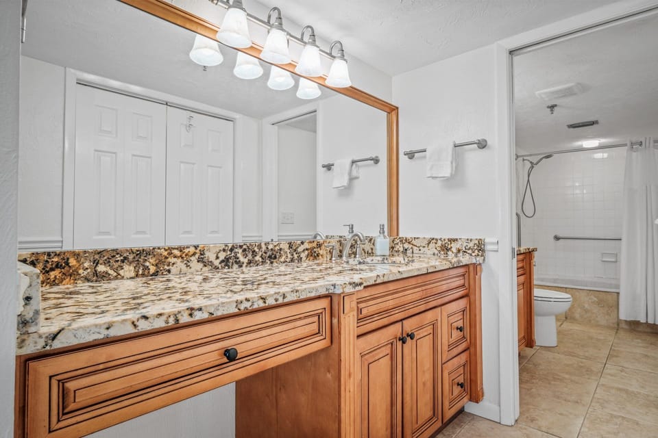 Ensuite master bathroom with a double vanity and large closet