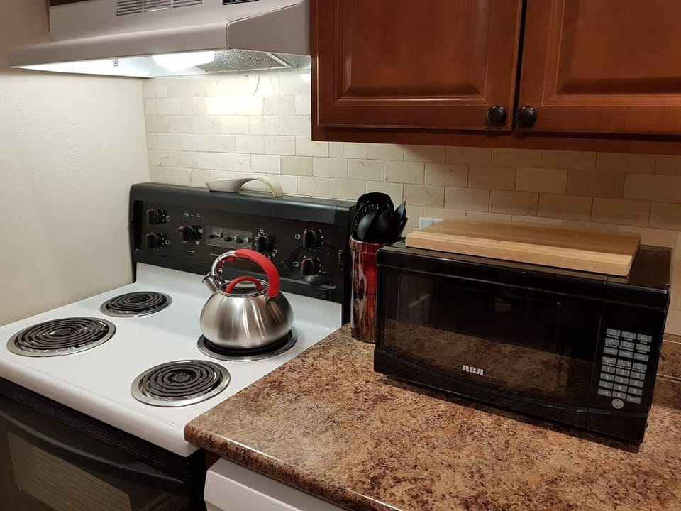 Easy to use microwave, traditional stove top kettle and selection of cooking utensils provided.