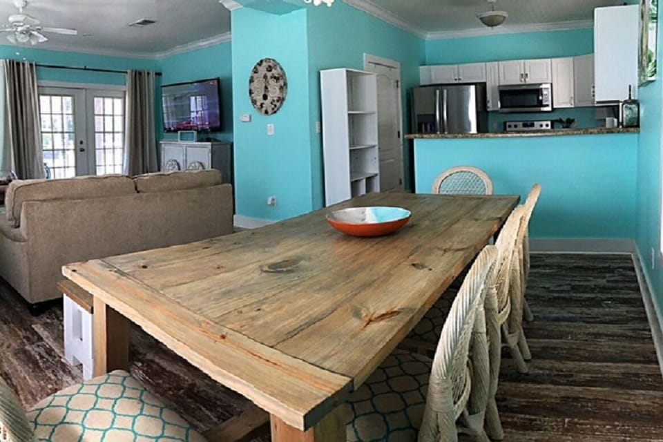 View from large dining table to kitchen and to front door