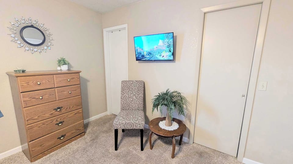 primary bedroom with a 36" Roku TV