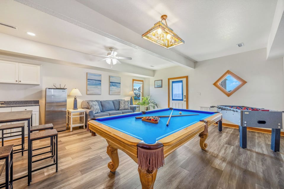 Challenge your group to friendly competition with a billiards table and foosball, then unwind in your cozy lounge—complete with kitchenette for snacks and drinks between games.