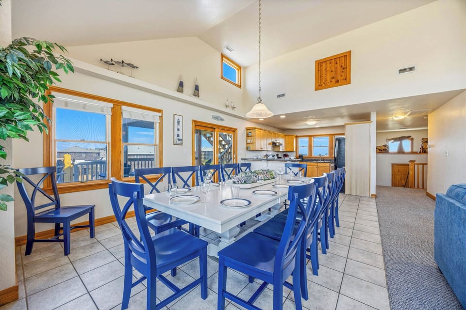 Gather around this stunning dining table with seating for ten, where your group can share meals while enjoying abundant natural light and gorgeous water views through the surrounding windows.