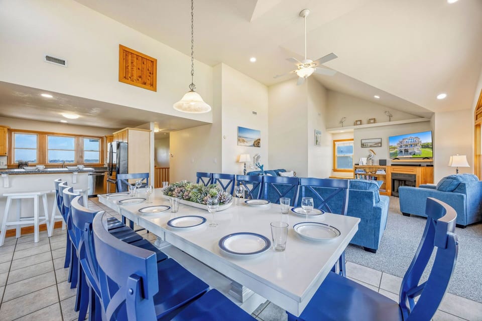 Gather around the spacious dining table with seating for your whole group, then relax in the open living room with ocean views framing your stay. Coastal charm meets comfort in every corner.