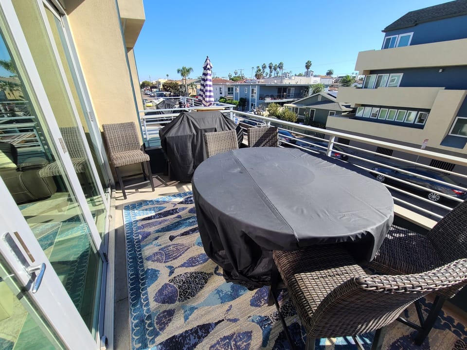 Balcony with BBQ and outdoor fire pit dining table