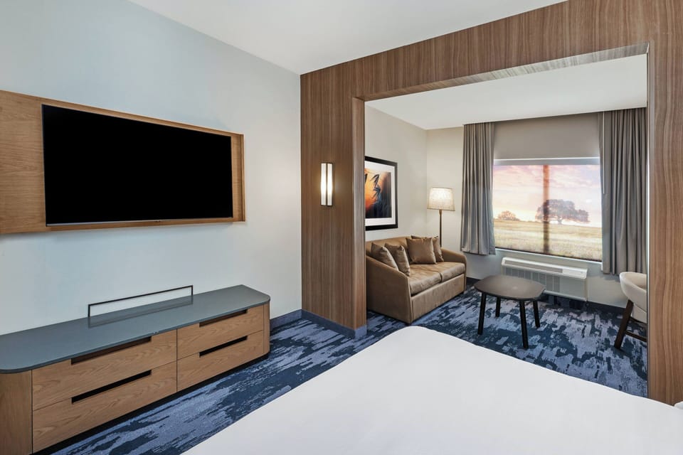 Hypo-allergenic bedding, desk, laptop workspace, blackout drapes