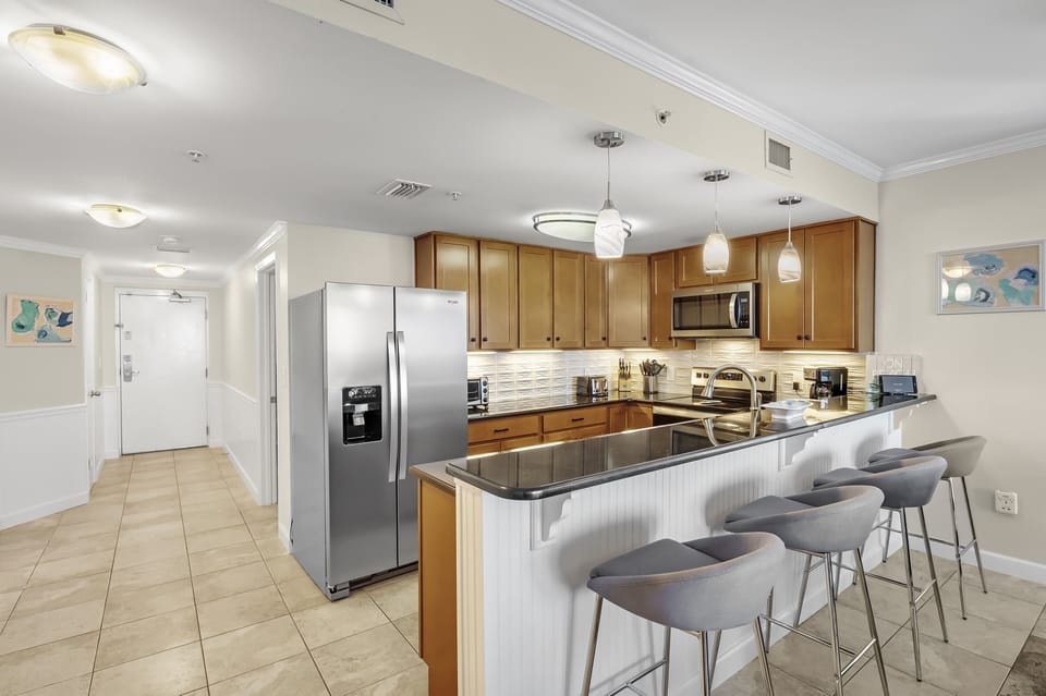 Full Size Kitchen with Granite Countertops, Stainless Steel Appliances and Extra Seating at the Breakfast Bar