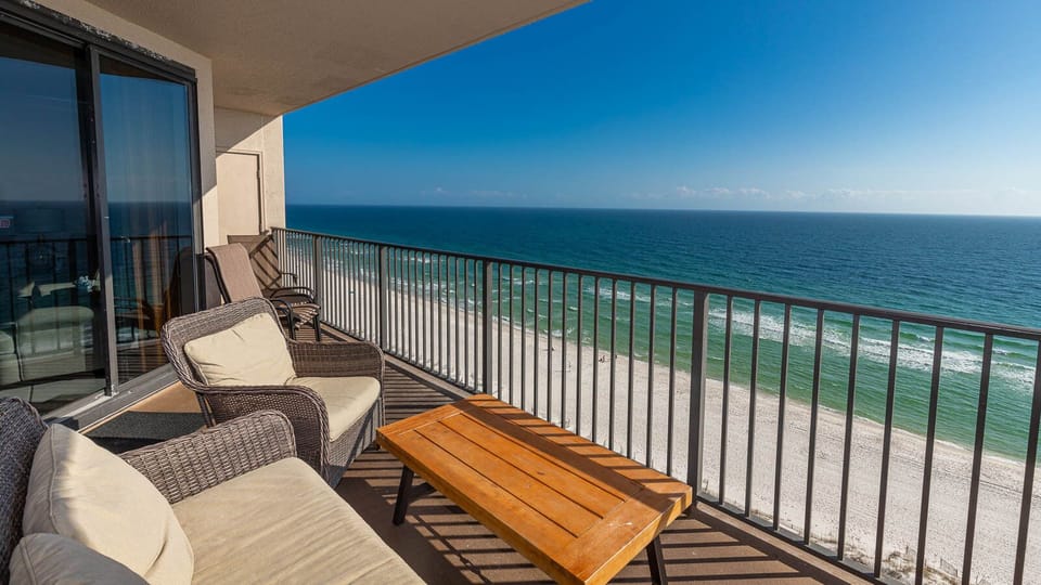 Enjoy the comfortable seating of the balcony while relaxing with expansive views of the tranquil waters and shoreline