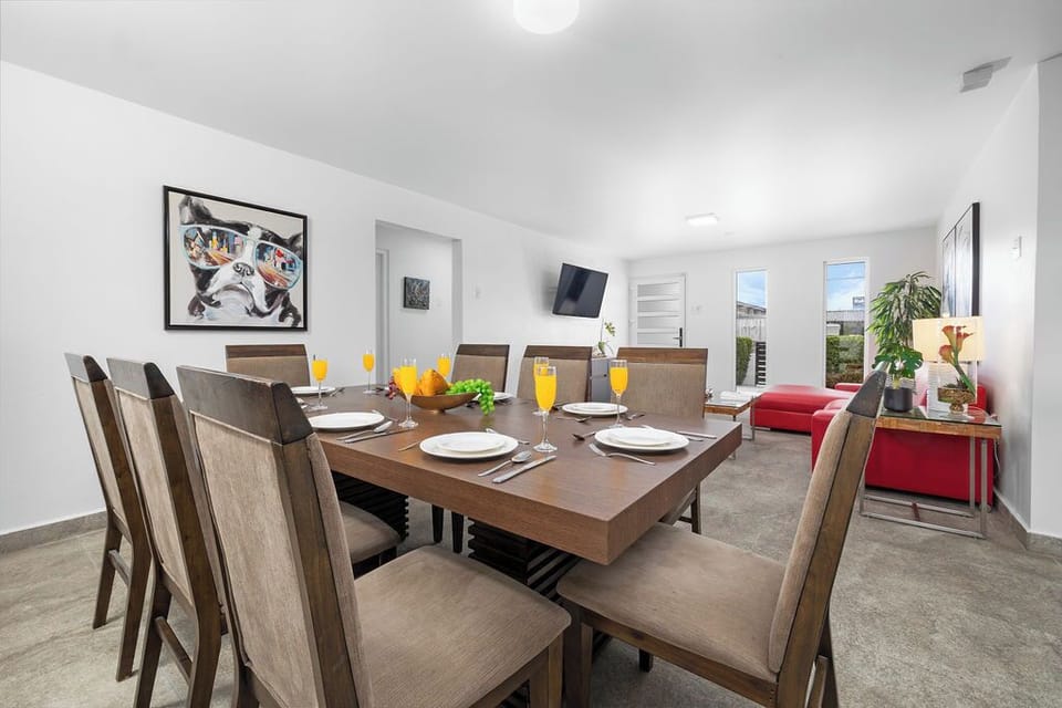A modern dining room with a large table for eight.