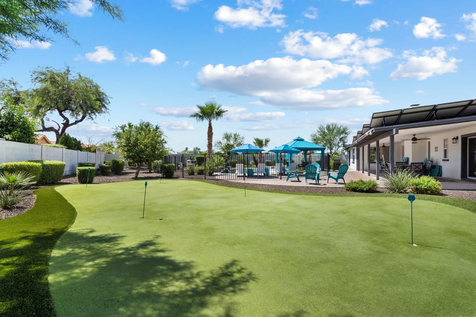 Outdoor oasis at the Turquiose House West including 2 large putting greens, pool