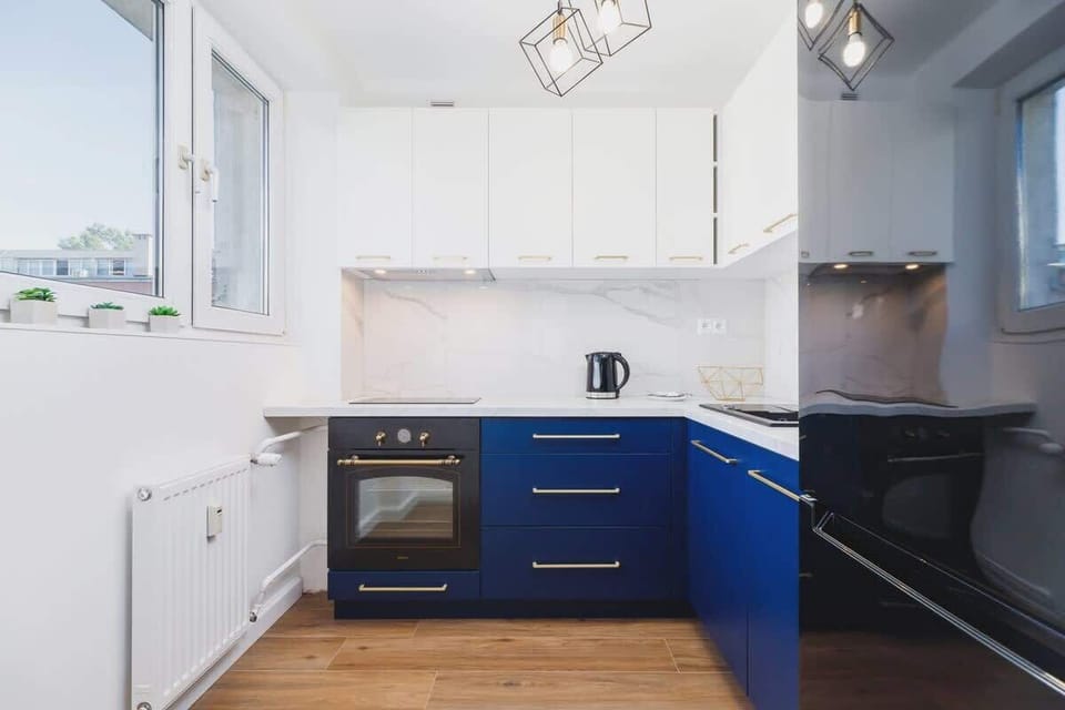 The kitchen's modern design includes a fridge-freezer and a toaster. 