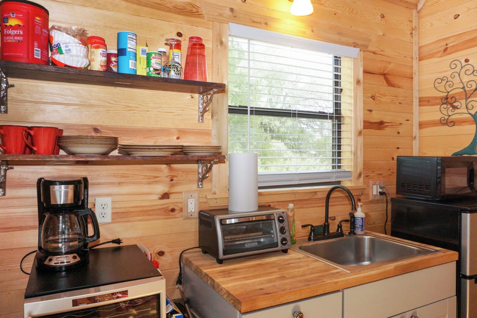 Kitchenette with refrigerator, coffee pot, toaster oven.