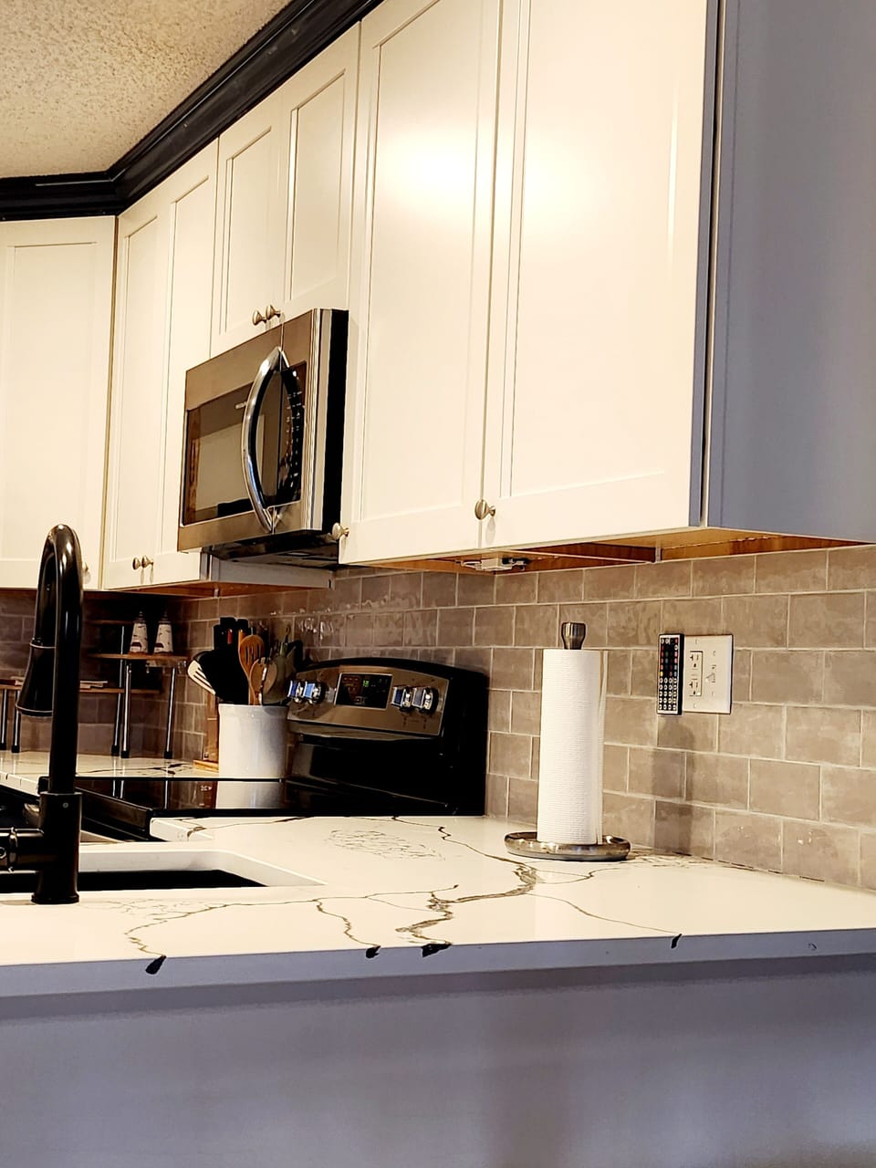 Immaculate backsplash with accent lighting.