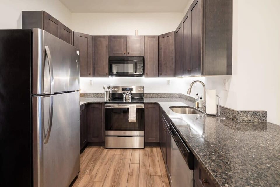 Enjoy home-cooked or the neighborhood's best takeout in this lovely kitchen with stainless steel appliances and a full-sized refrigerator.