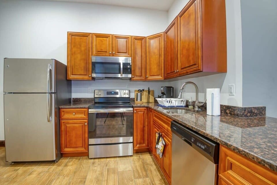 Enjoy home-cooked or the neighborhood's best takeout in this lovely kitchen with stainless steel appliances, a microwave, and a full-sized refrigerator.