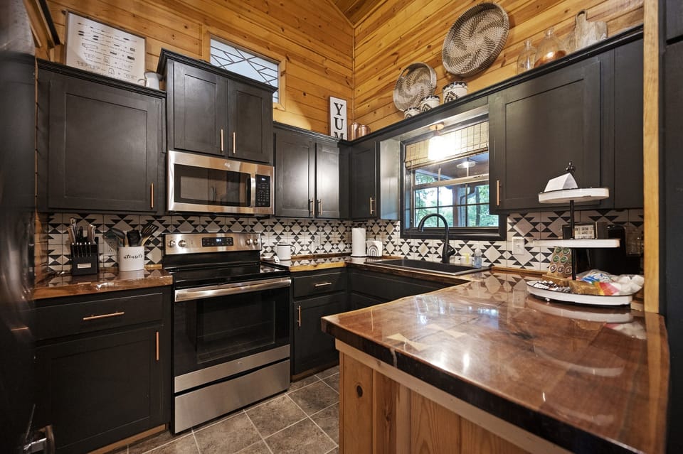 The kitchen is small, but fully stocked with full sized appliances!