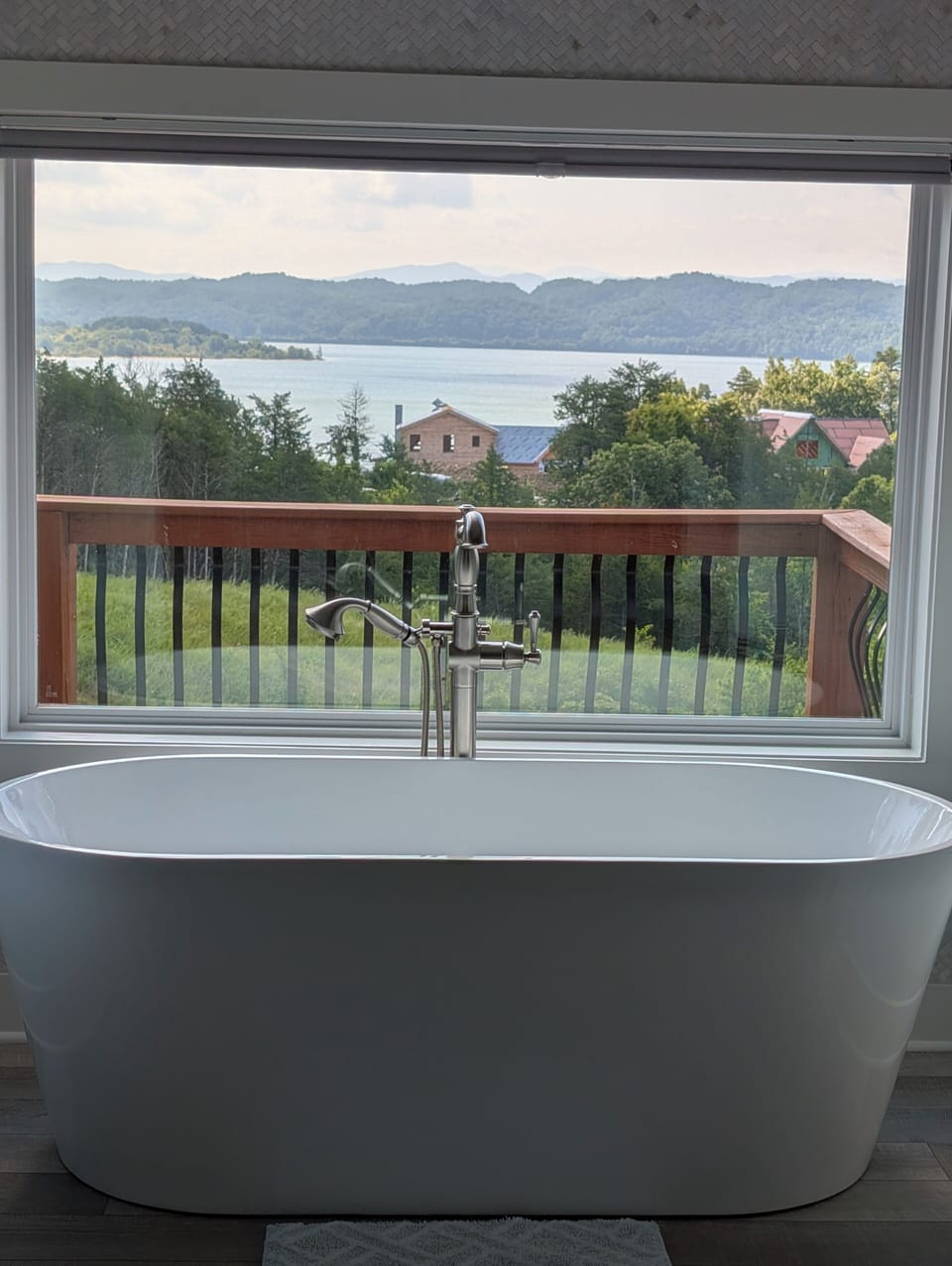 Soaking tub in master bathroom with lake & mountain views