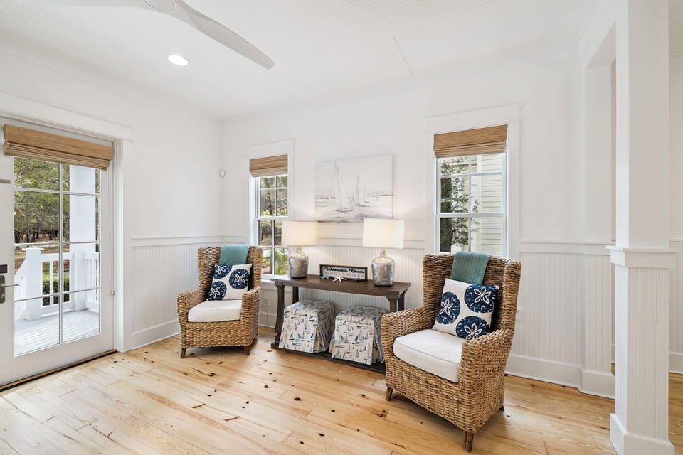 Sink into coastal comfort in your bright living room, where wicker chairs and nautical touches create the perfect spot to unwind after beach days.