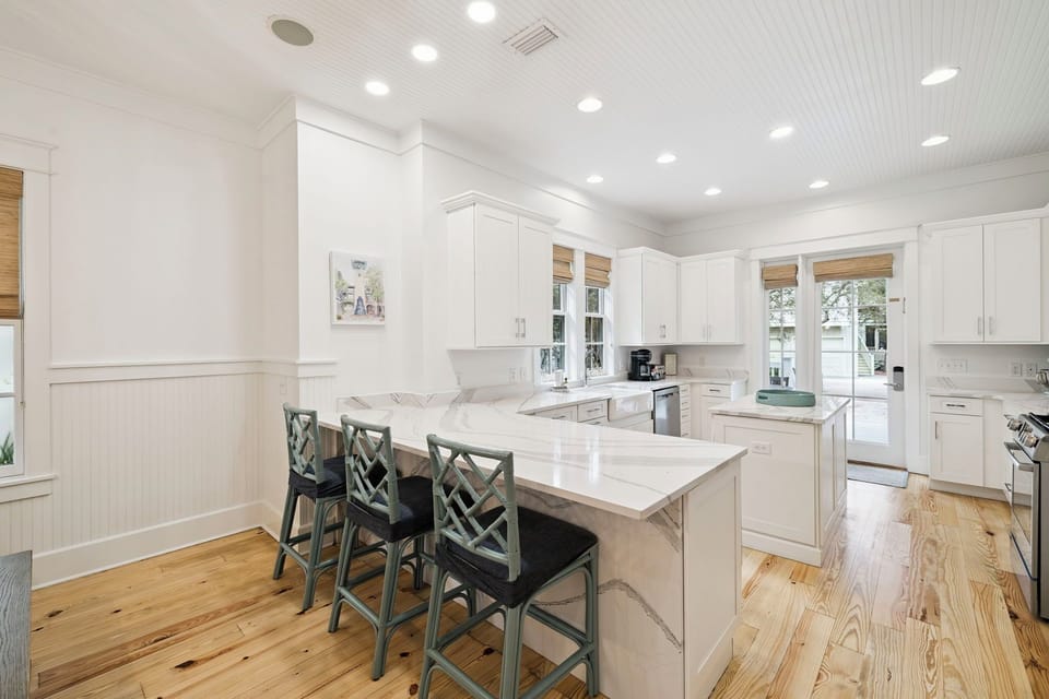 Gather around this spacious marble island where you can share morning coffee and evening conversations in this beautifully appointed kitchen.