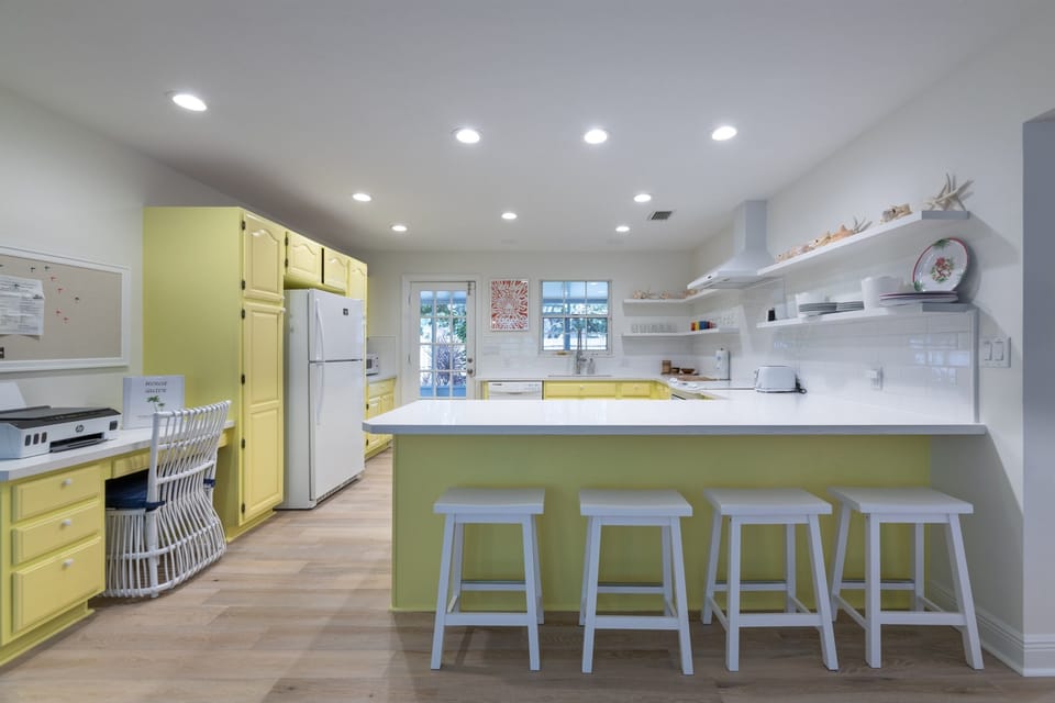 A fully- equipped chef's kitchen. 4 Counter stools at the kitchen counter, and direct access to the screened patio.