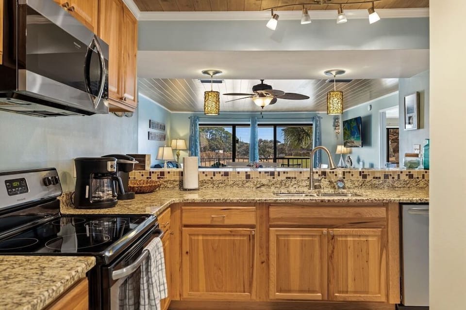 Kitchen view looking into dining and den areas