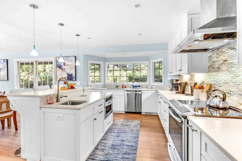 Your gourmet kitchen awaits with gleaming countertops, professional appliances, and abundant natural light streaming through garden windows.