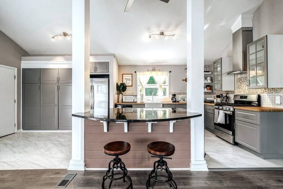 Big kitchen island and storage cabinets. Sits two more.