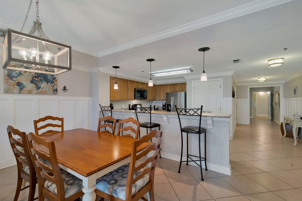 Dining room consists of 6 person table and 3 barstools