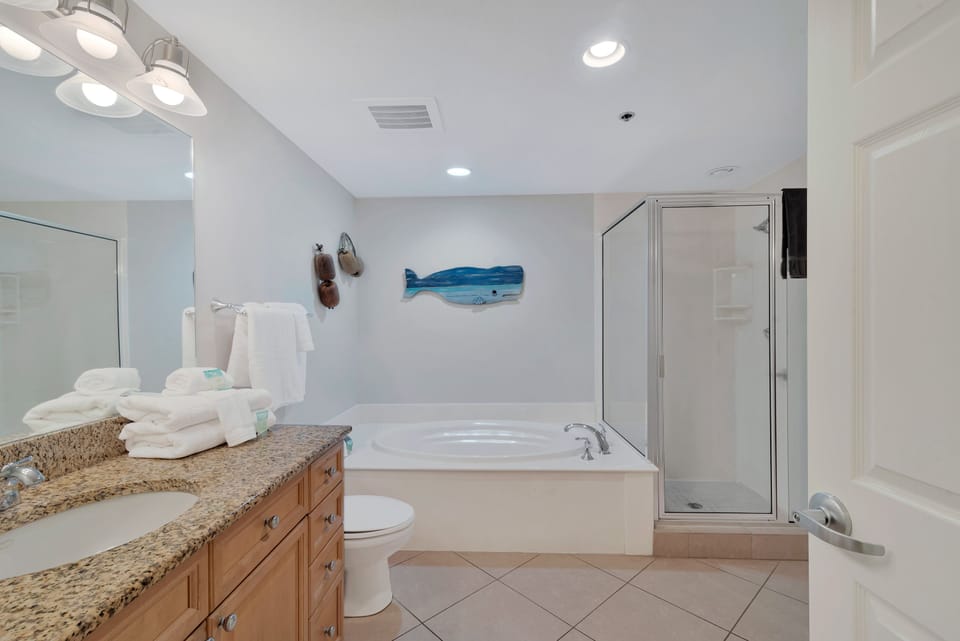 2nd bathroom has jacuzzi jetted soaking tub and a shower with glass surround