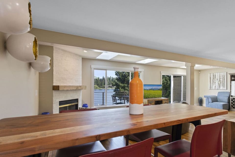Eating area with bar height table, next to kitchen with captivating view of the lake.