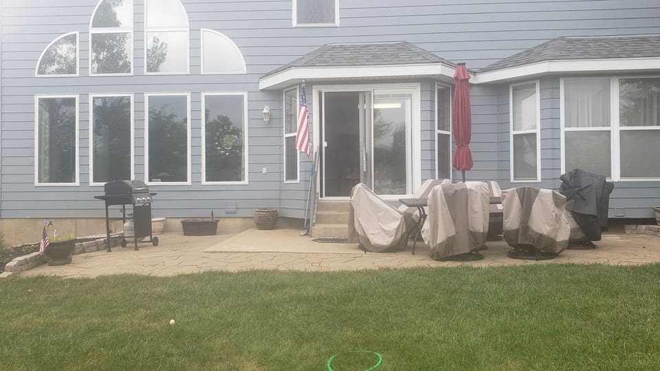 Patio with Chairs, Umbrella, Barbecue Grill to enjoy meals on the Patio