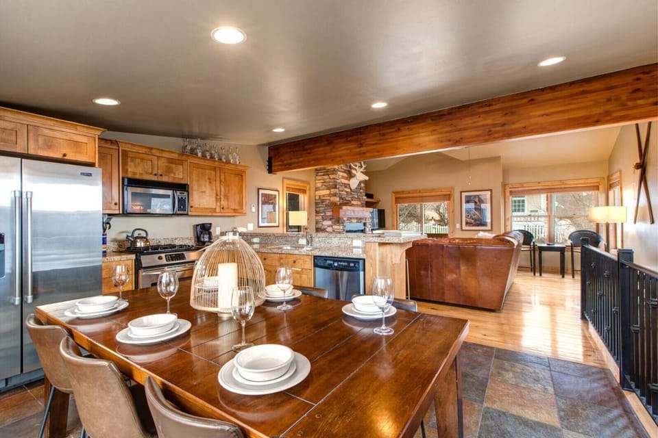 Gather around the dining table for six, set against warm wood tones that create the ideal setting for family dinners and game nights.