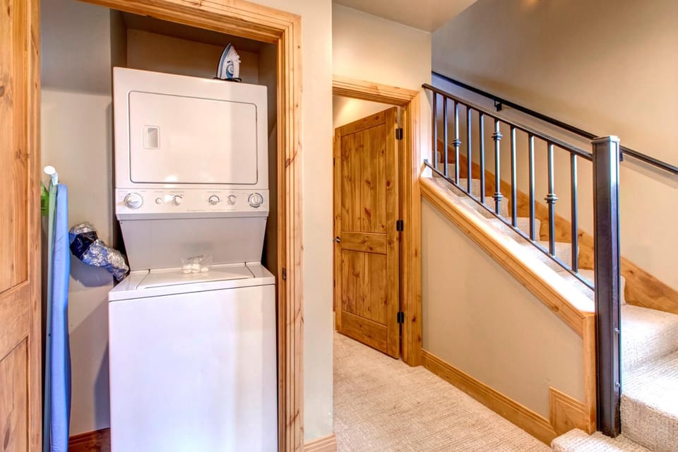 Laundry room with stackable washer and dryer keeps everything fresh for longer visits.