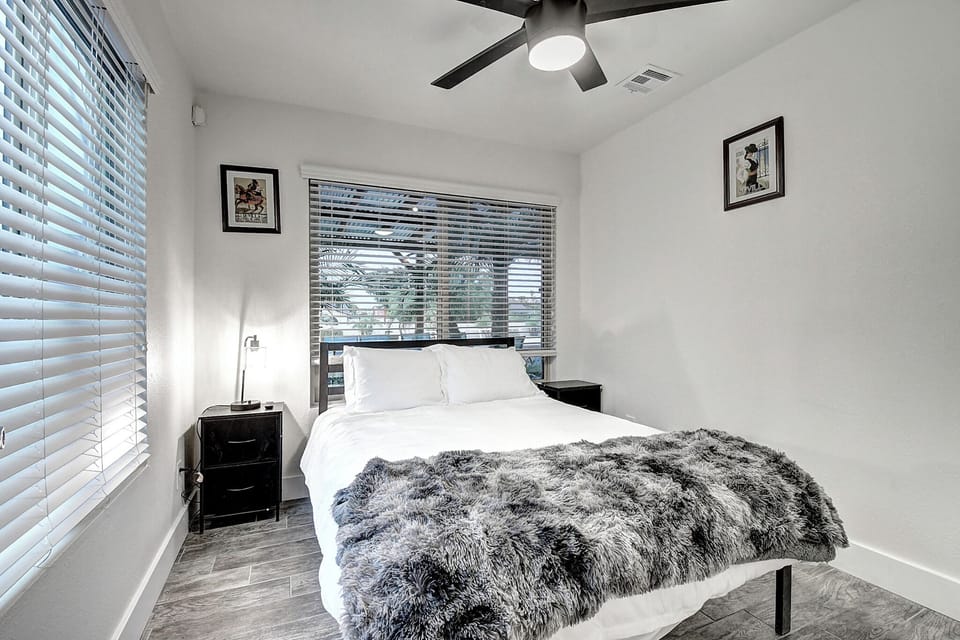 8th bedroom off the theater room with a double bed-TV
