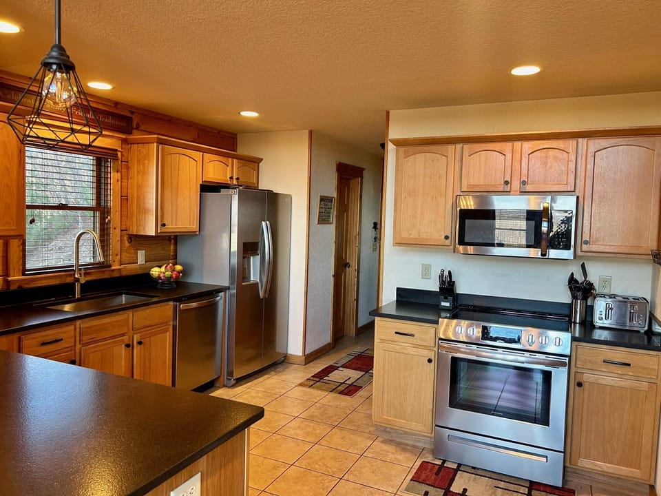 Kitchen is fully equipped with dishes, all cookware, and has new appliances. 