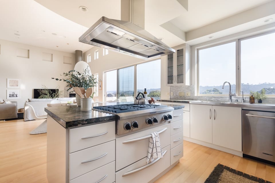 Kitchen features an island and modern appliances for all your cooking needs.