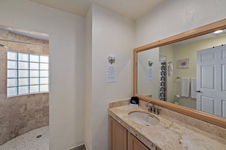 Clean and bright bathroom with full amenities and plush towels provided.