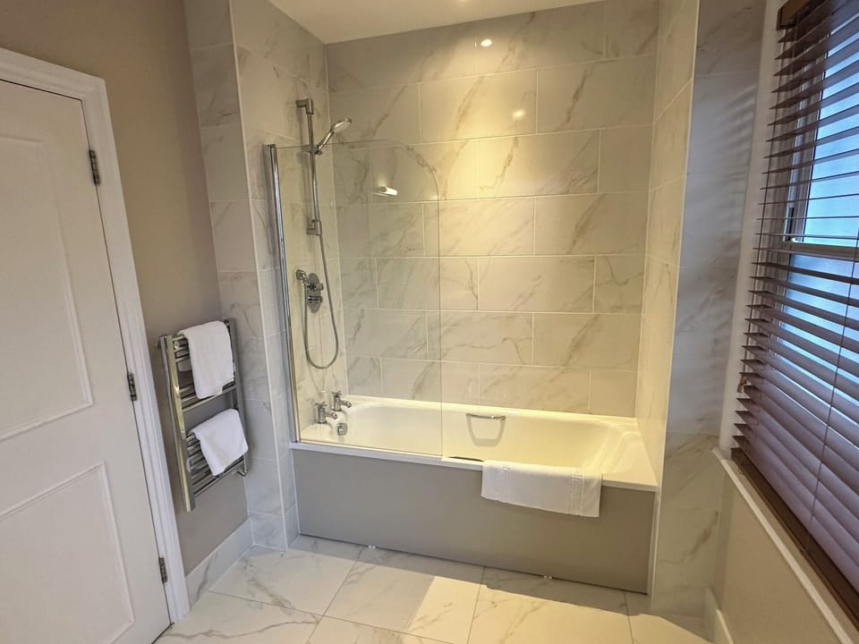 Combined shower/tub, hair dryer, towels, soap