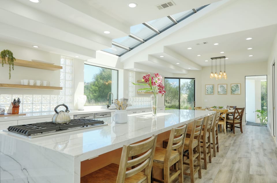 A central island provides ample seating -an ideal gathering space to brew morning espressos and evening tea.