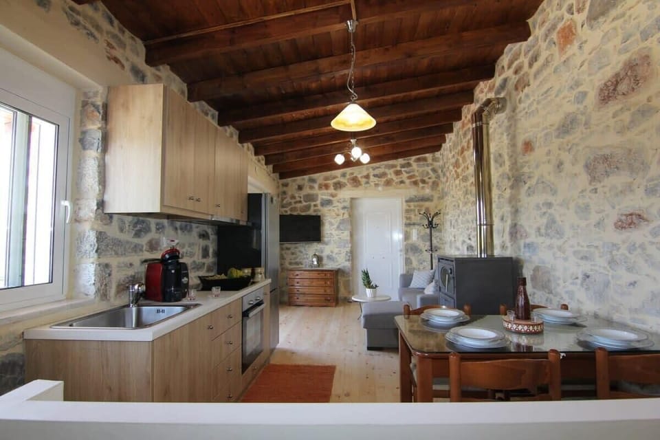 Relax in the Traditional Stone Living Room – A cozy lounge with rustic stone walls and wooden beams, perfect for unwinding.