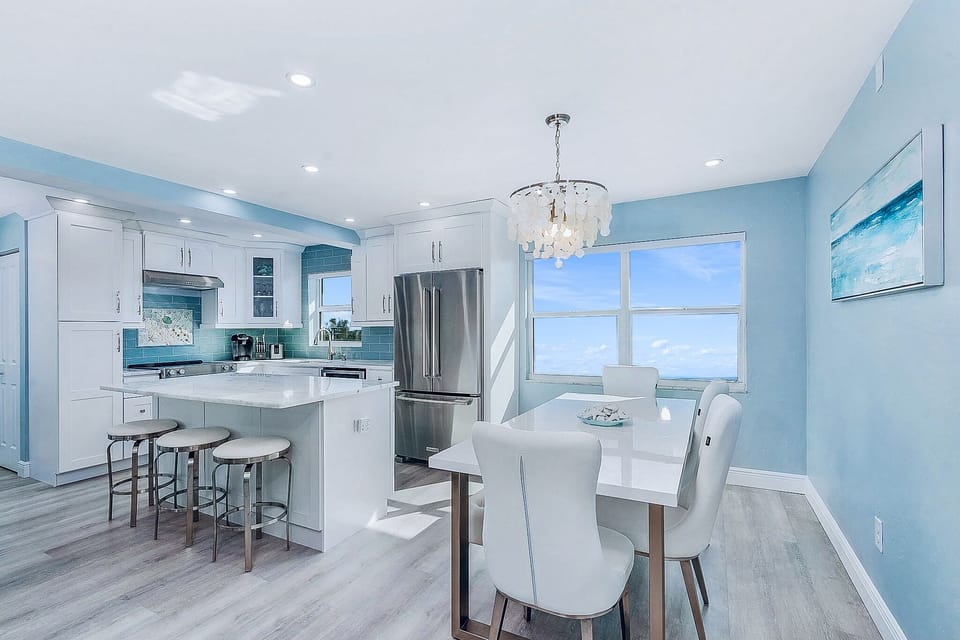 Fully stocked kitchen with island seating and dining room.