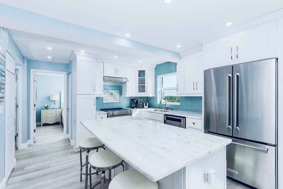 Spacious eat in kitchen with KitchenAid appliances and microwave drawer.