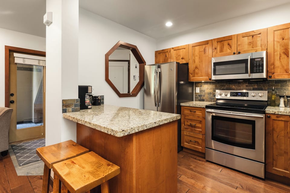 Kitchen - Modern stainless steel appliances, quartz countertops, FULLY equipped with cooking utensils.