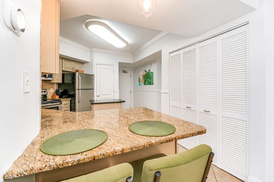 Breakfast bar seating with pendant lighting at White Caps 305 renovated Orange Beach condo
