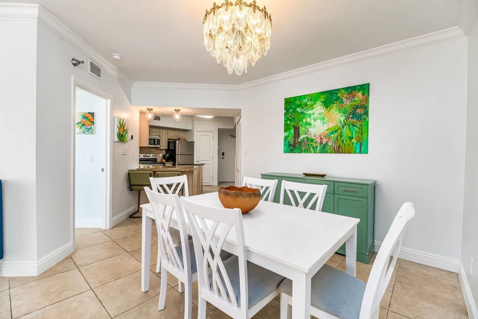 Elegant dining area seats 6 under statement chandelier - perfect for family meals in Orange Beach