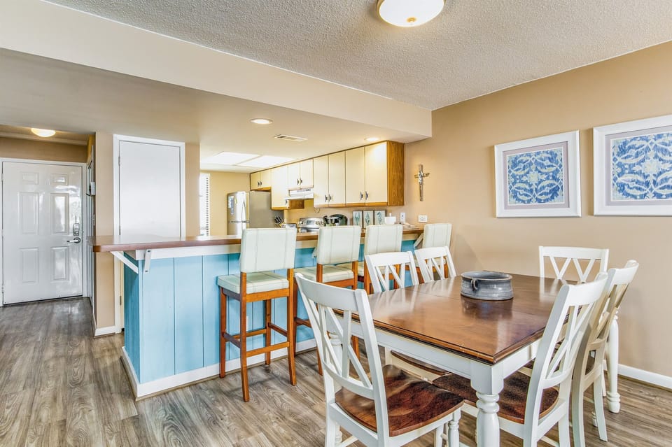Open-concept dining with comfortable seating for 6 and stunning Old River views at Wind Drift Orange Beach bayfront condo