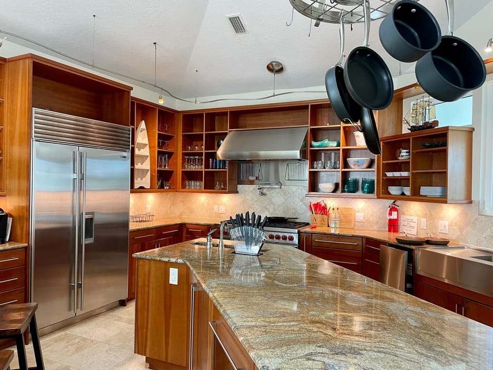 Chef's kitchen with Sub Zero fridge, stocked w/ cooking and baking needs