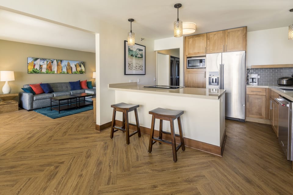 Relax in your spacious open-concept suite where kitchen, living, and dining flow seamlessly together. Stainless appliances, elegant lighting, and stylish beach-inspired décor create a comfortable home base for your getaway.